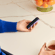 Hand holding a Ploom device with Lavender Back Cover