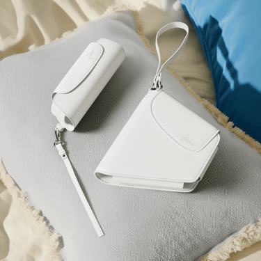 Ploom AURA Glacier White Solo and Duo Carry Case accessories on a cushion.