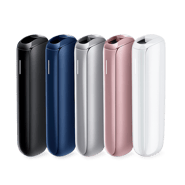 Four Ploom AURA heated tobacco devices in Jet Black, Navy Blue, Lunar Silver, and Rose Gold colors standing side by side